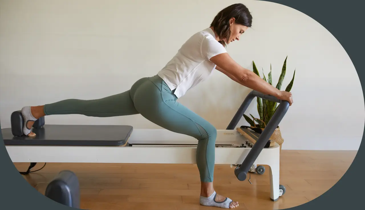 Instructor on a Reformer machine